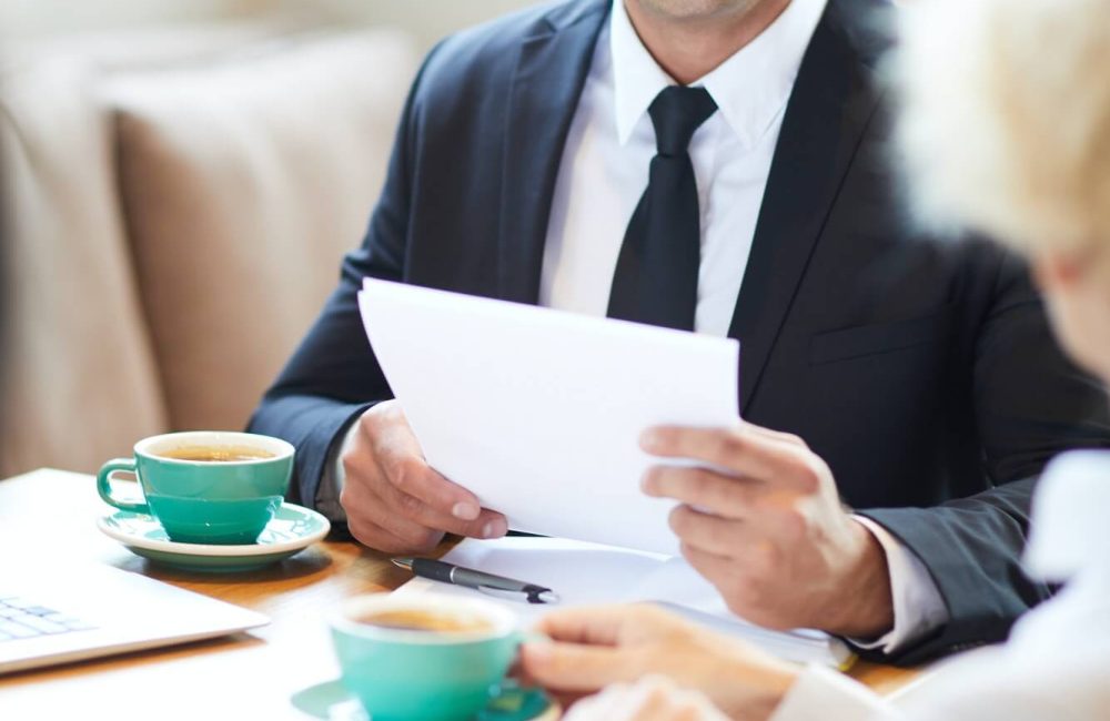 cheerful-lawyer-talking-to-client-in-cafe-1.jpg